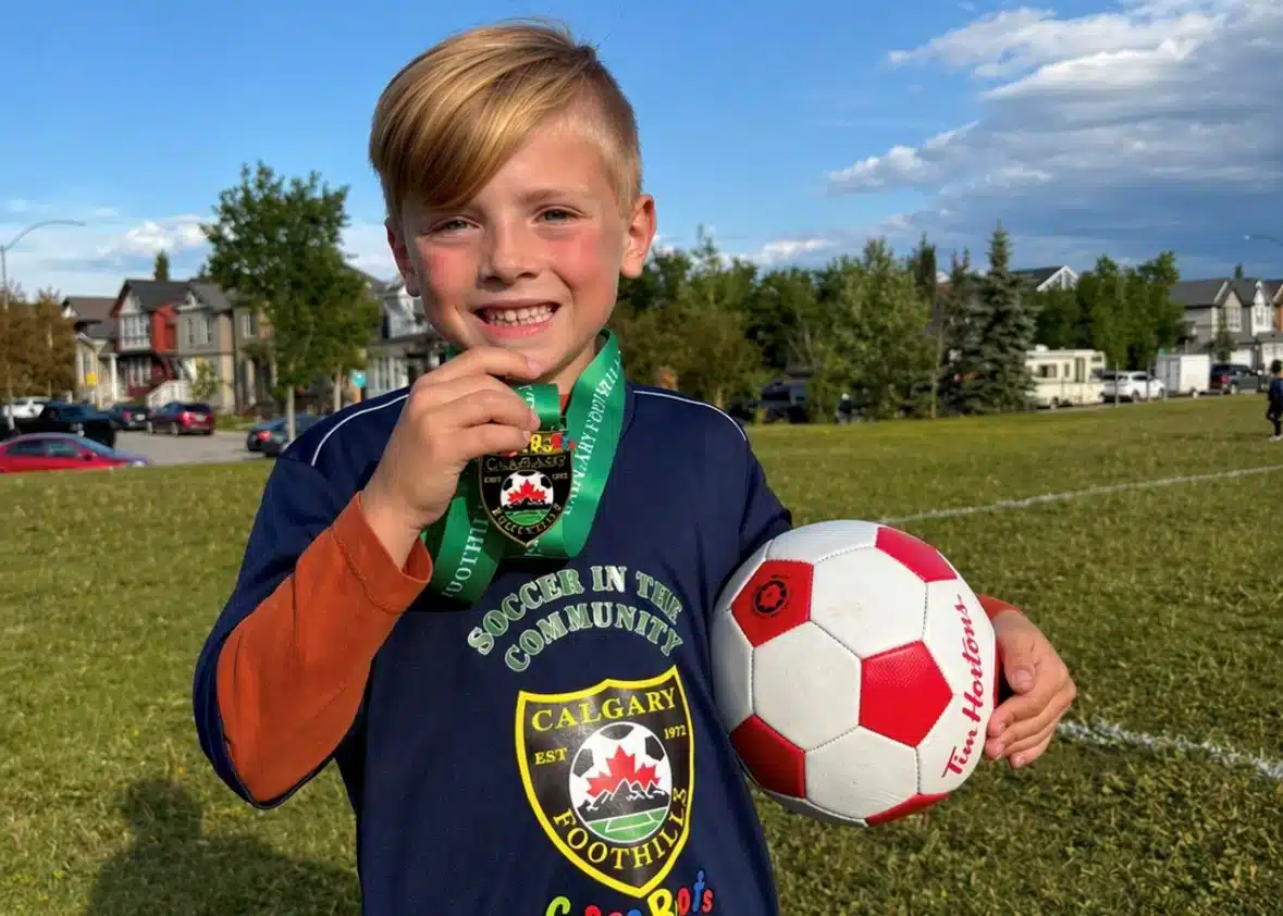 Young soccer player with a medal